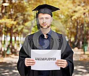 Portrait, graduation and unemployment with a student man holding a sign outdoor for debt, loans or jobless. Economy
