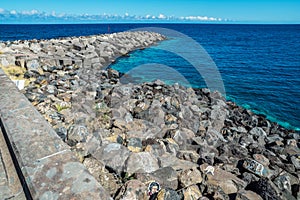 Portrait graffiti art of famous artists, musicians and singers on stones of breakwater in the Santa Cruz de Tenerife. Editorial