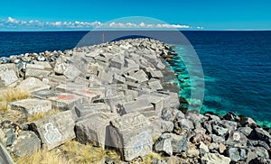 Portrait graffiti art of famous artists, musicians and singers on stones of breakwater in the Santa Cruz de Tenerife. Editorial