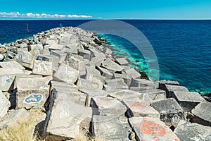 Portrait graffiti art of famous artists, musicians and singers on stones of breakwater in the Santa Cruz de Tenerife. Editorial