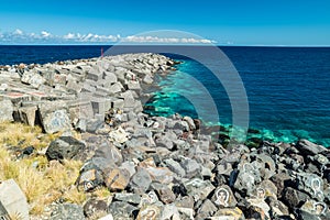 Portrait graffiti art of famous artists, musicians and singers on stones of breakwater in the Santa Cruz de Tenerife. Editorial