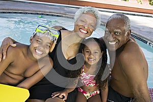 Portrait Of Grandchildren With Grandparents By Swimming Pool photo