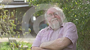 Portrait of grandfather elderly retired senior man at retirement age outdoors