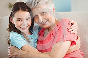 Portrait of grandmother and granddaughter embracing