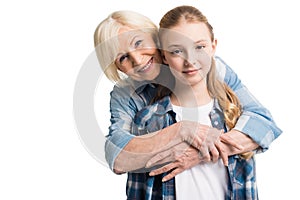 Portrait of grandmother and granddaughter embracing