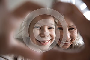 Portrait of grandmother and granddaughter make selfie together