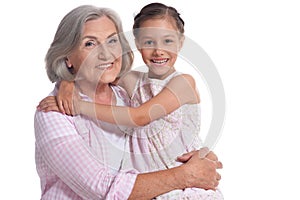 Portrait of grandmother hugging with her cute granddaughter