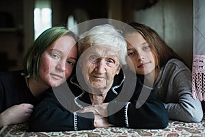 Portrait of grandmother with two girl great-granddaughters