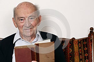 Portrait of a grandpa reading a book