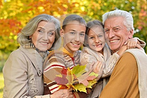 Portrait of grandparents spending time with grandchildren in park