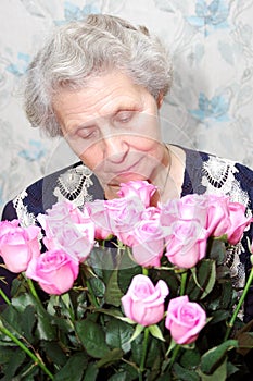 Portrait of granny behind bouquet of pink rose