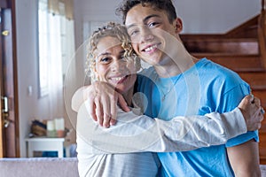 Portrait of grateful teenager man hug smiling middle-aged mother show love and care, thankful happy grown-up son in embrace