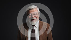 Portrait of gray-haired adult smiling and looking happy