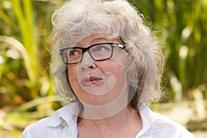 Portrait of gray-haired woman outdoors