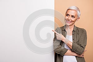 Portrait of gray short hair business woman promoting copyspace banner dynamics stats team growth isolated on beige color