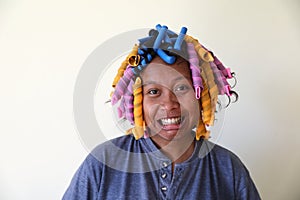 Portrait of grinning girl in curlers