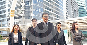 Portrait Group of businesspeople arms crossed smiling look at camera in modern city background. Happy Businessman, businesswoman