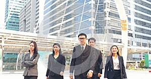 Portrait Group of businesspeople arms crossed smiling look at camera in modern city background. Happy Businessman, businesswoman