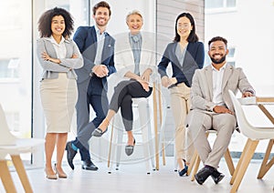 Portrait of a group of confident diverse businesspeople posing together in an office. Happy smiling colleagues motivated