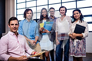 Portrait of a group of coworkers holding folders