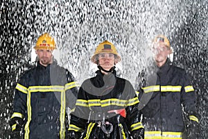 Portrait of a group of firefighters standing and walking brave and optimistic with a female as team leader.