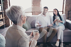 Portrait of group friendly corporate coworkers sit couch drink coffee loft interior modern office indoors