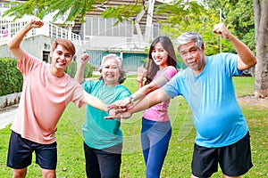 Portrait of a group of people exercising outdoors in the morning They gave thumbs up. and smiling happily.