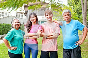 Portrait of a group of people exercising outdoors in the morning They smile happily.