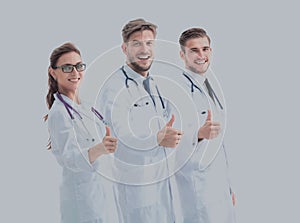 Team of medical professionals looking at camera, showing thumbs