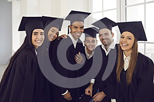 Portrait of a group of students of different nationalities posing by the window in classroom.