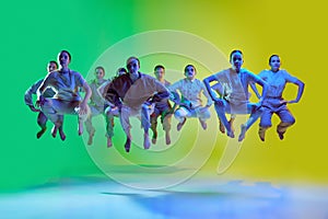 Portrait with group of teenagers, young dancers jumping up together over green and yellow gradient background in neon