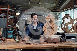 Portrait of guitar luthier small business owner in workroom