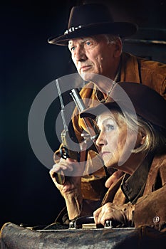 Portrait of gunslingers in western garment on black