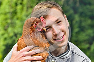 Portrait of a guy with a chicken in his hands