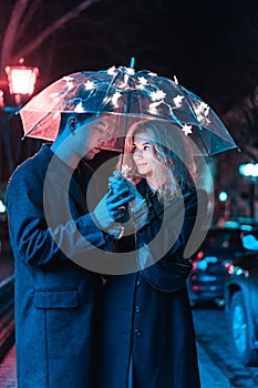 Portrait of a guy and a girl under an umbrella