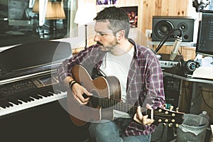 Portrait of a guy with a guitar. Musician guitarist in studio