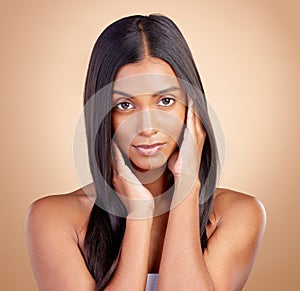 Portrait, hair care and Indian woman with beauty, makeup and dermatology on a brown studio background. Face, female