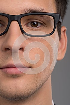 Portrait of half face of man looking at camera.