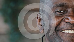 Portrait half male face african american adult 50s man with wrinkles toothy smiling elderly businessman senior
