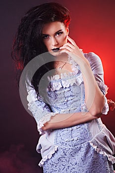 Portrait of halloween vampire woman aristocrat with stage makeup