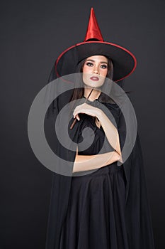 Portrait of Halloween Witch girl, Beautiful young Asian women holding magic wand