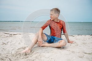 Portrait of handsom teen boy on beautiful beach at summer holidays