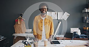 Portrait of handsome African American designer smiling standing at work