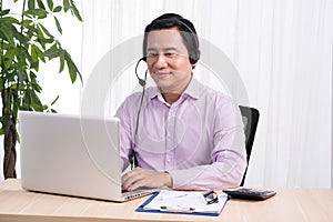 Portrait of handsome asian hotline person consultant wearing headset