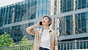 Portrait of handsome Asian student using smartphone