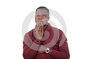 Astonished young man covering mouth with hand