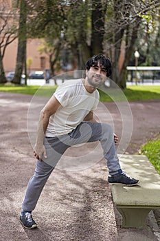 Portrait of handsome attractive mature bearded athletic latin man guy 40s doing stretching exercise