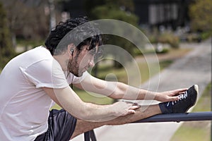 Portrait of handsome attractive mature bearded athletic latin man guy 40s doing stretching exercise