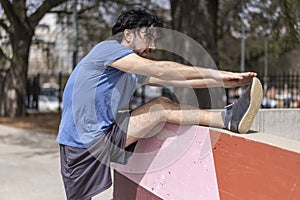 Portrait of handsome attractive mature bearded athletic latin man guy 40s doing stretching exercise