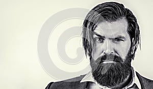 Portrait of handsome bearded man in suit. Male beard and mustache. Sexy male, brutal macho, hipster. Black and white